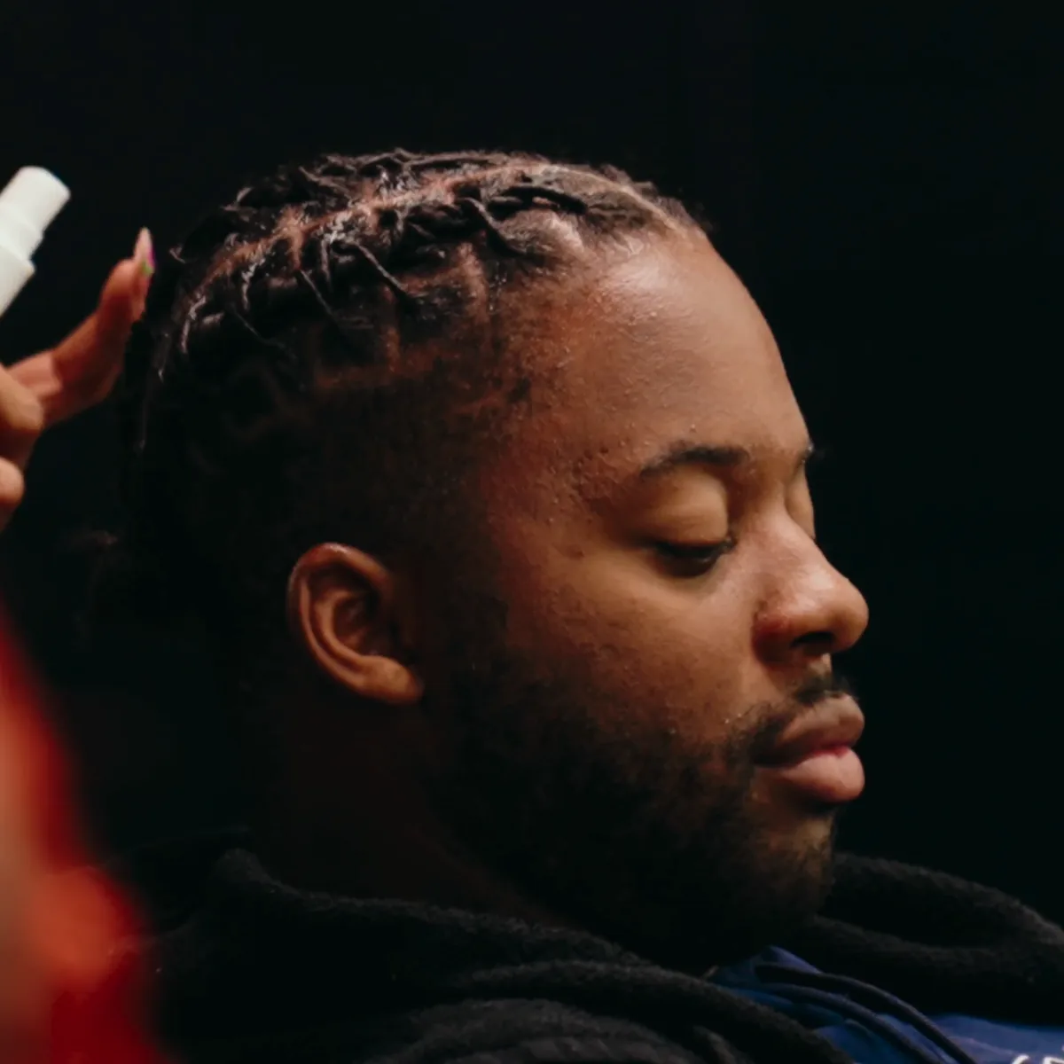 The same client in the same chair: cornrows half done with the rest of the hair still loose, then the finished cornrows.