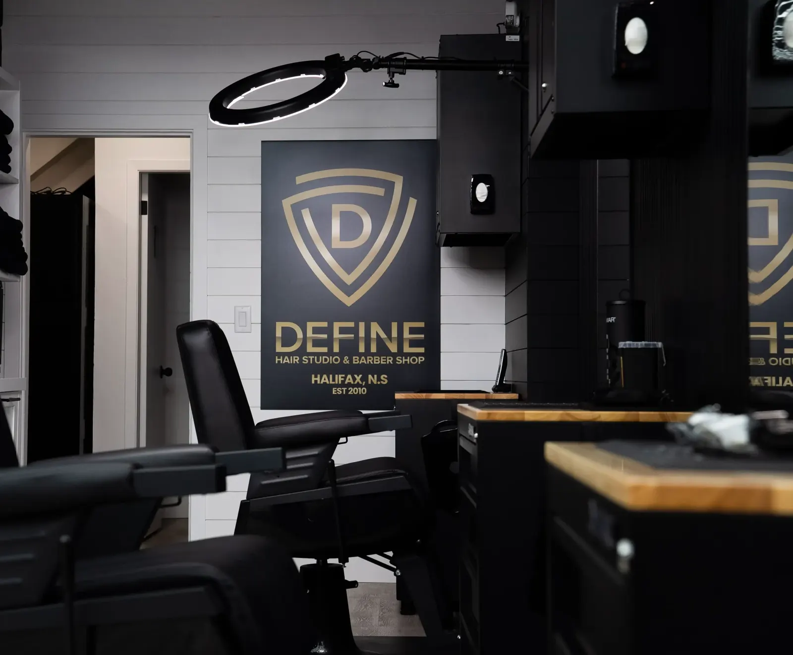 The Define shield logo on the wall beside a station
