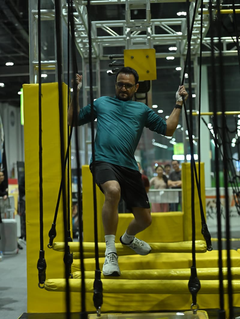 A competitor jumping across the stepping blocks on the ninja course