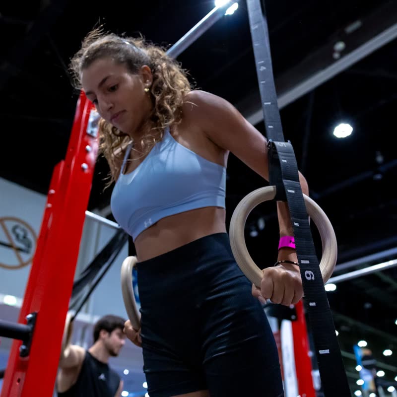 A competitor holding the gymnastic rings