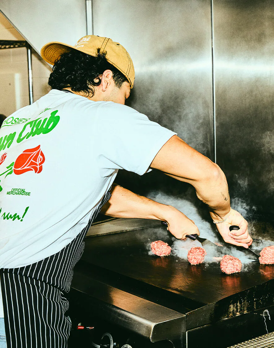 Two Rosie's crew members in aprons at the counter