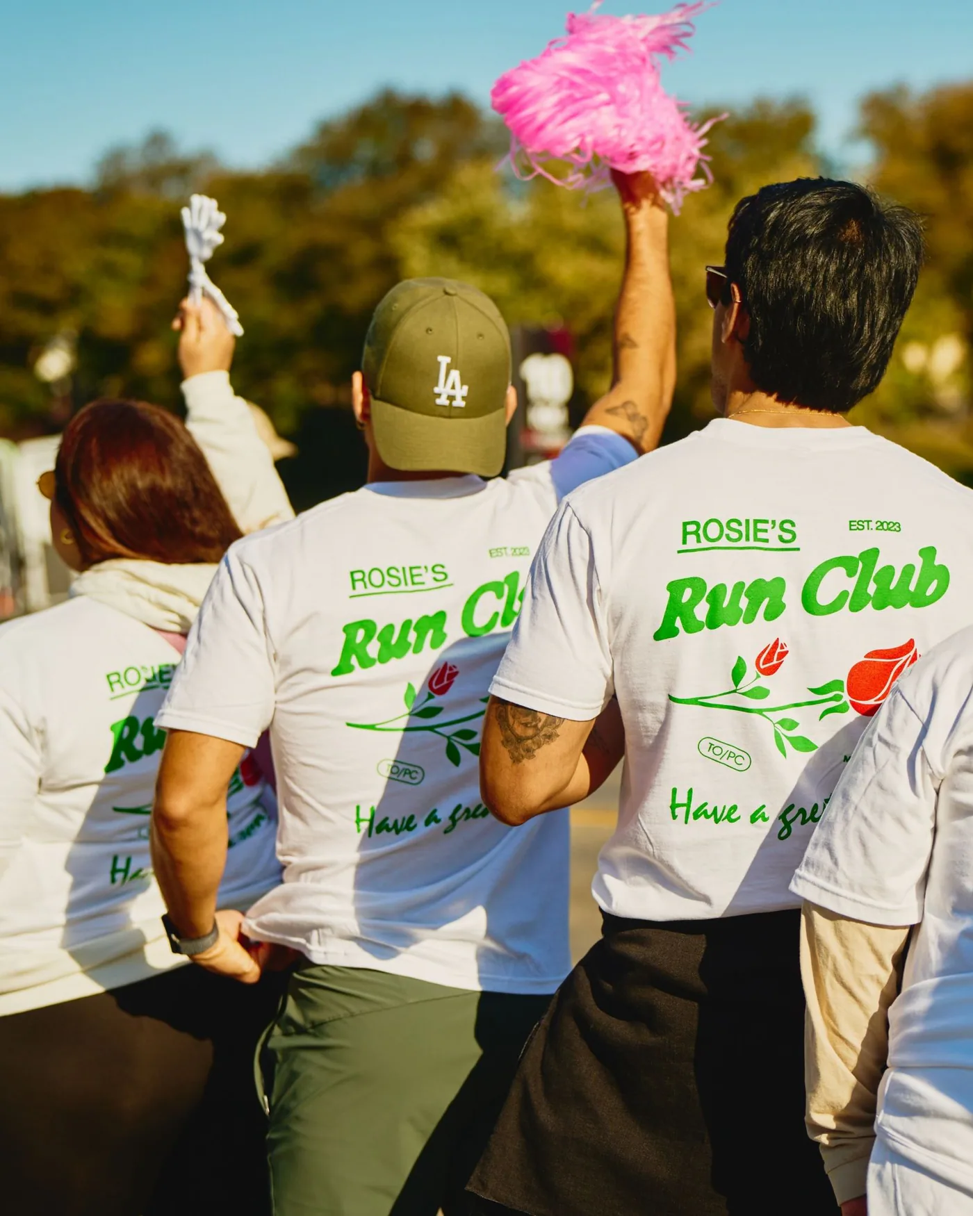 Runners in Rosie's Run Club shirts, backs to the camera