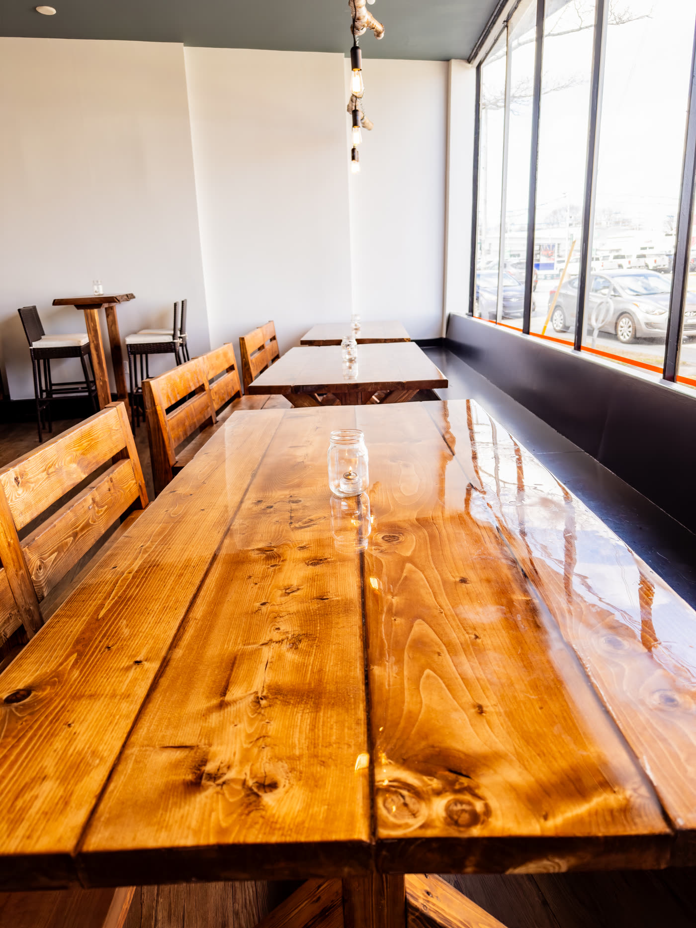 The long wooden tables and benches along the windows of The Bonfire