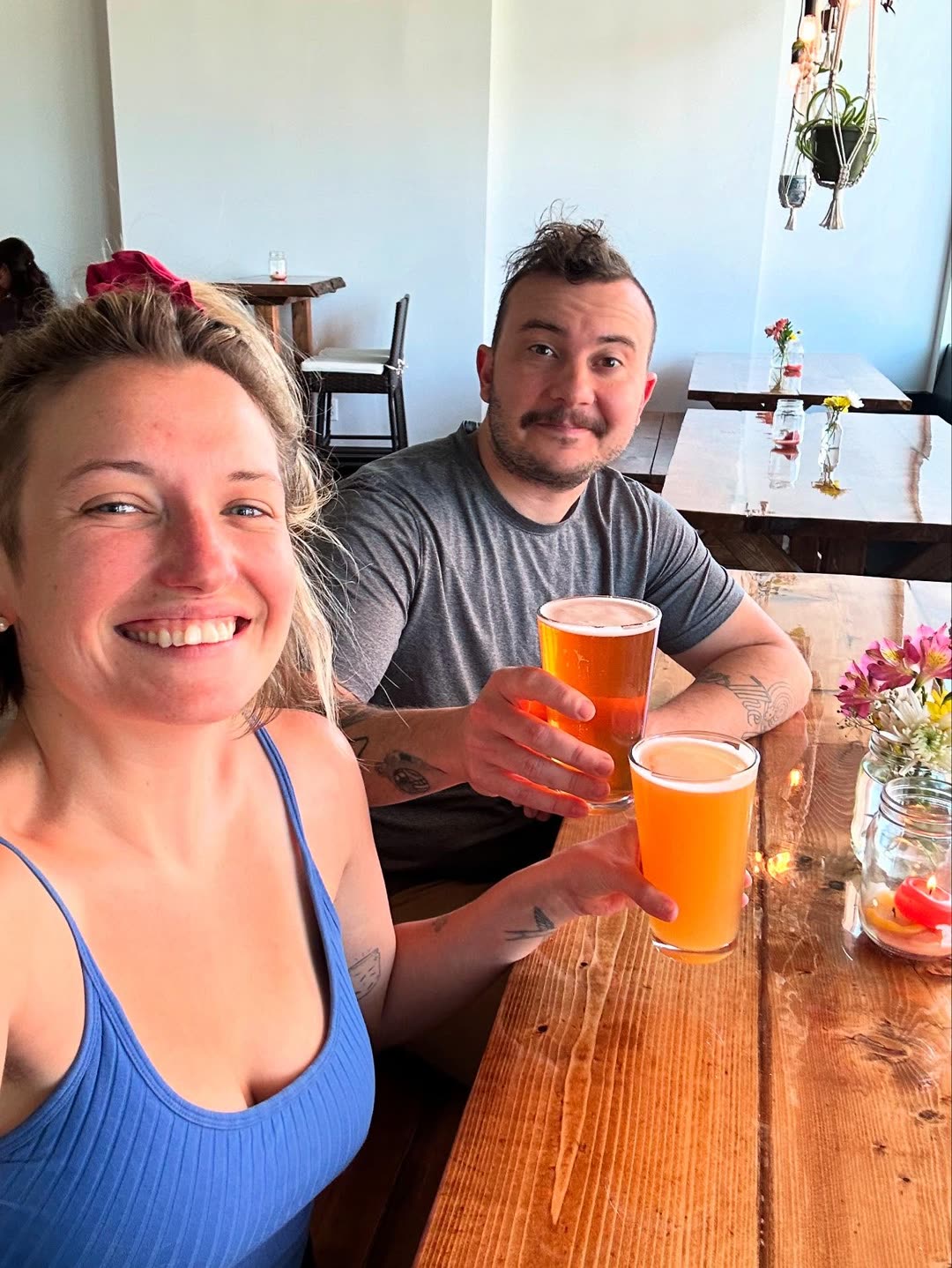 Kristyn and Vince with two pints at one of their tables